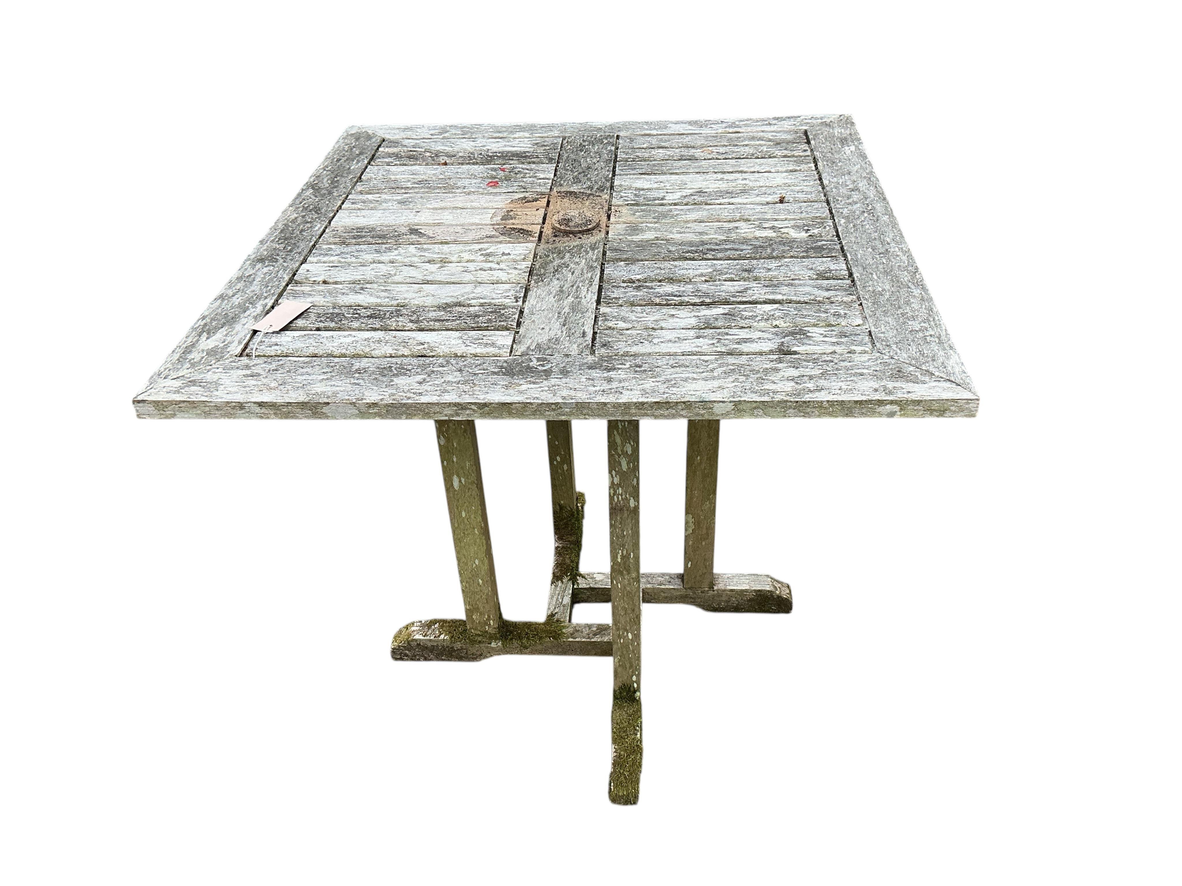 A Lindsey weathered teak square garden table, width 79cm, height 73cm and two chairs
